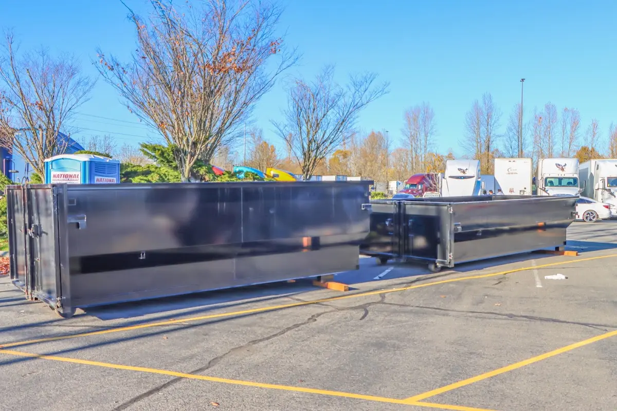 Professional dumpster rental service with roll-off container on residential driveway in Verona